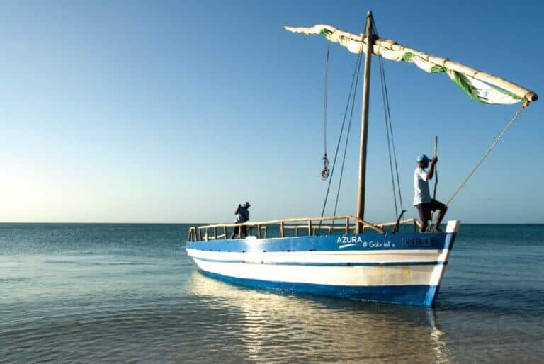 a large blue and white dhow in the ocean of Mozambique