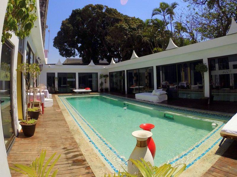 large pool area with sunbeds at Villa das Arabias Boutique Hotel