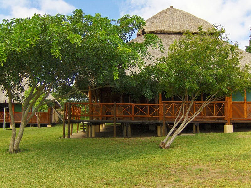 Exterior view of a lodge with two trees outside in Archipelago Resort