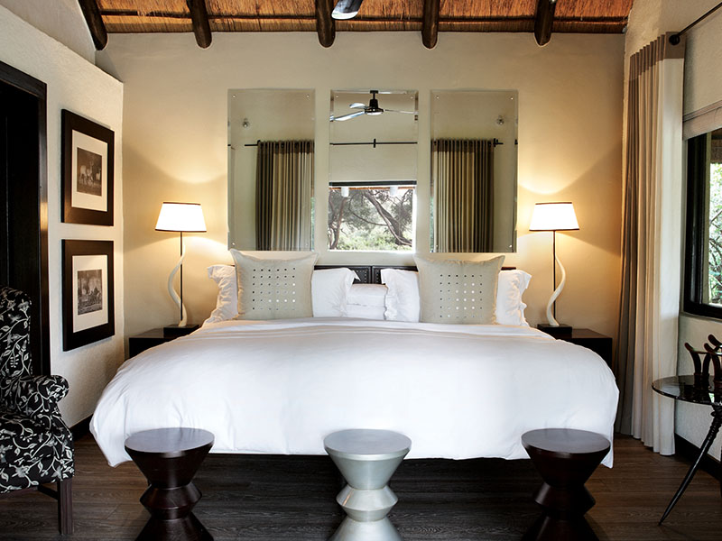 double bed and bedroom interior of Londolozi Varty Camp in Kruger National Park