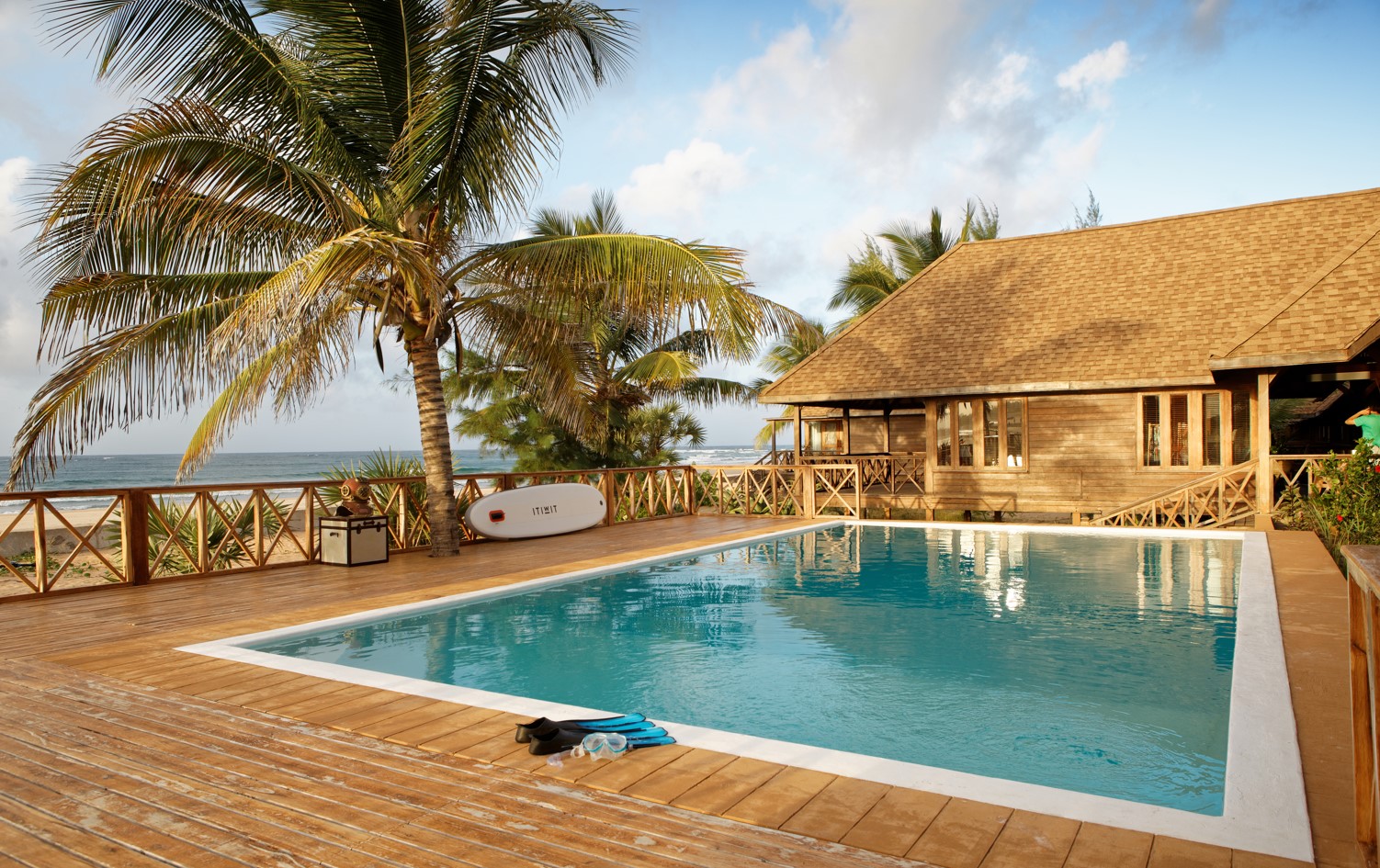 Outdoor swimming pool surrounded by the deck and sunbeds at Sentidos Beach Retreat in Inhambane