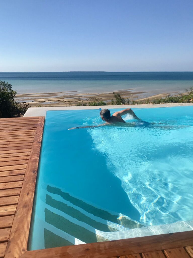 a man swimming at the pool in As Dunas Resort