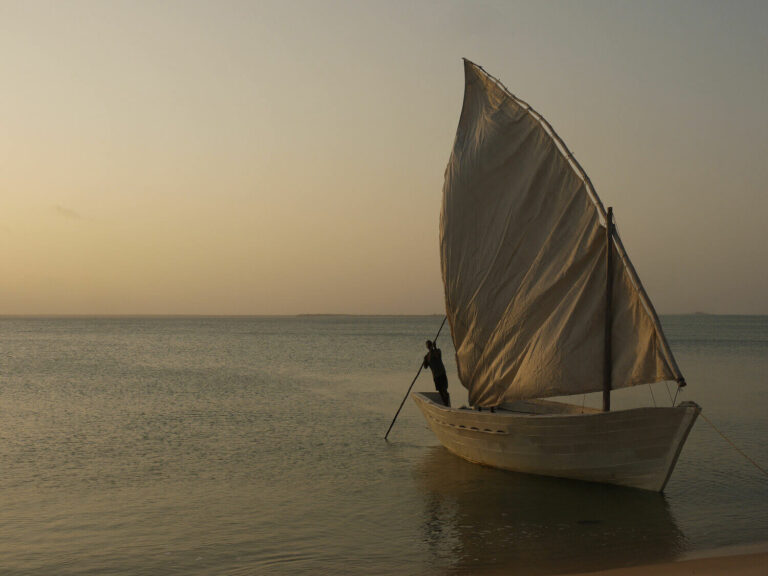 Dhow with white sail in the ocean in Mozambique