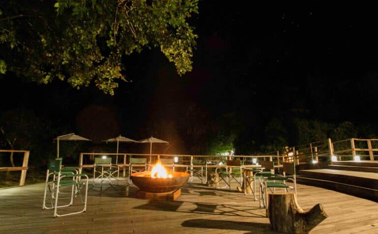 A lit fire pit on the deck of the camp in Gorongosa National Park